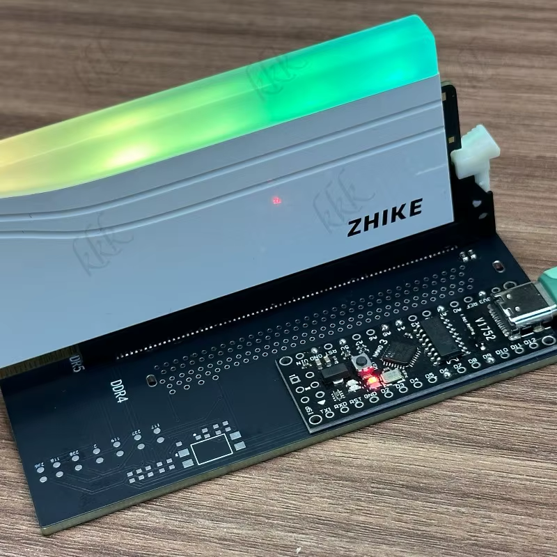 A DDR4/DDR5 SPD programmer module clipped onto a RAM stick to read and rewrite its serial data